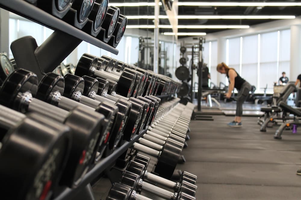 Athlete loading a barbell in a quiet gym
